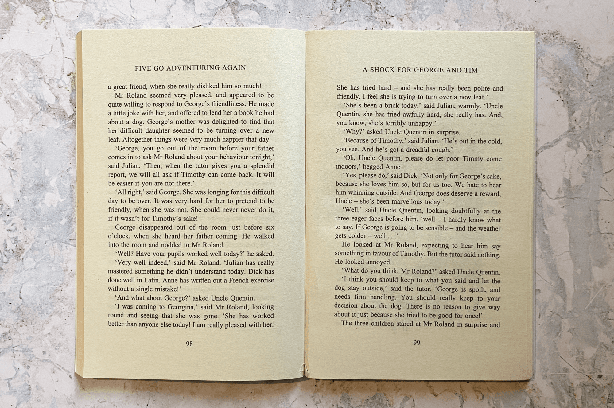 Open physical book pages showing traditional two-column text layout